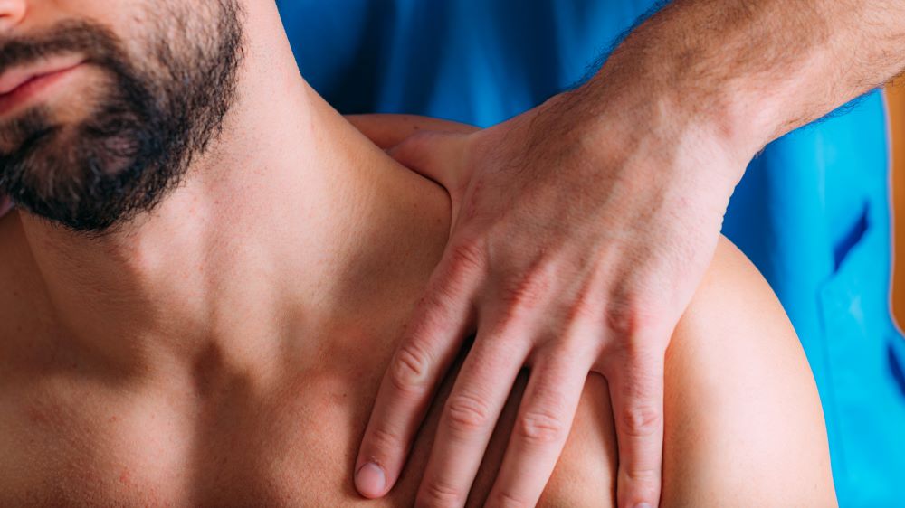 A male massage therapist massages his attractive shirtless male client. Staying grounded: an antidote to our fast digital world.