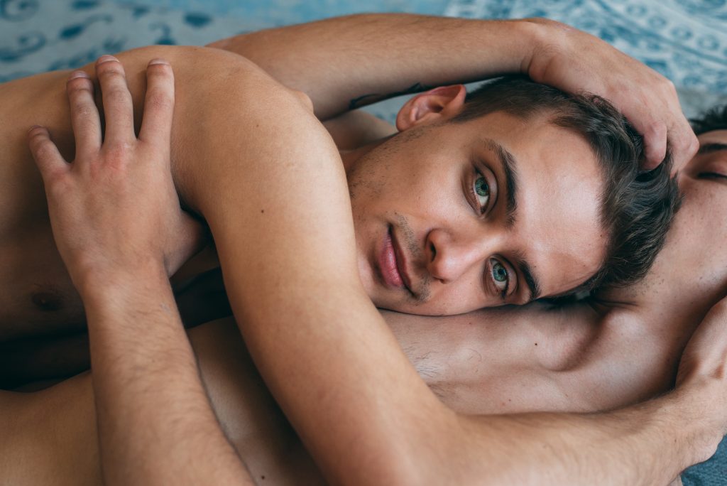 Exploring the Sensuality of ASMR: The Relaxing Magic of Sensual Massage. Passionate sexual naked gay couple in an intimate moment laying down.