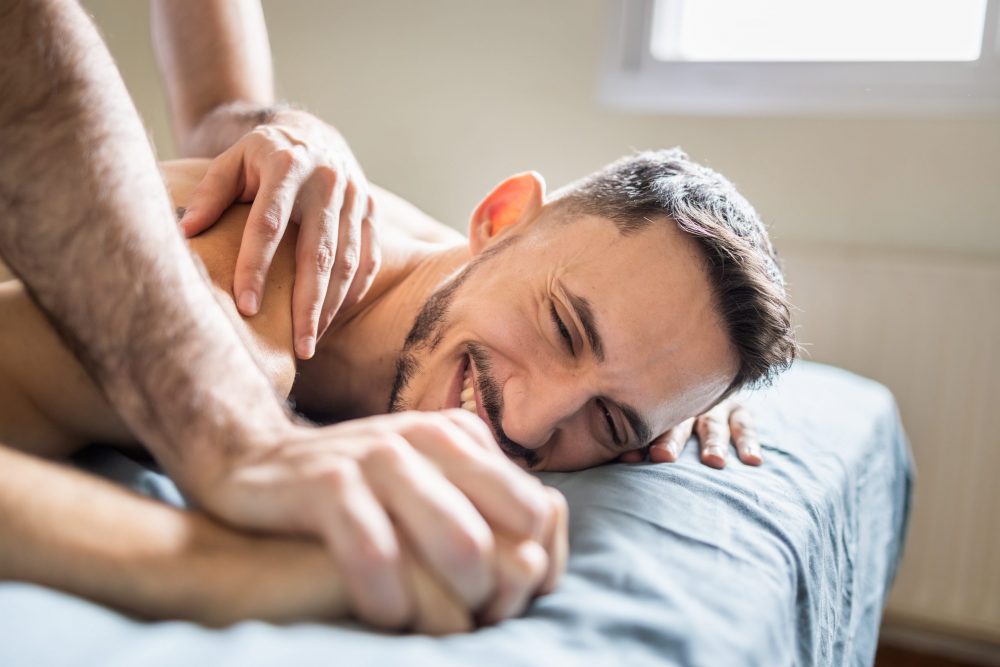 a man getting a sensual erotic massage from his partner