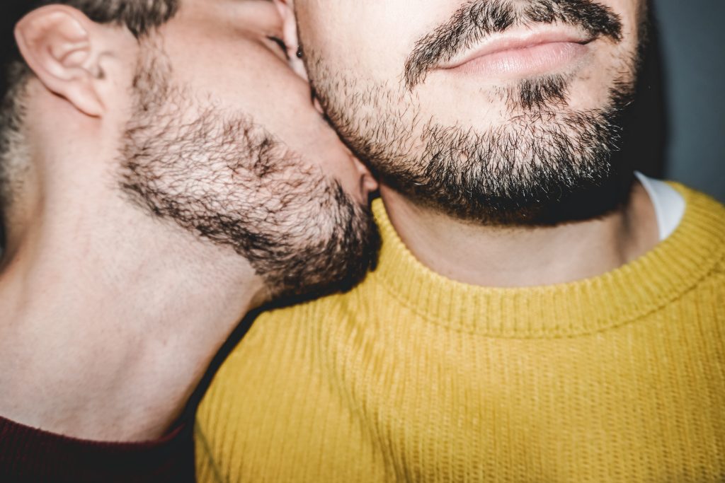 Everything Erogenous: The Magic Zones that Will Make Him Tingle. Gay male couple kissing on the neck - Lgbt, homosexual love concept - Vintage filter