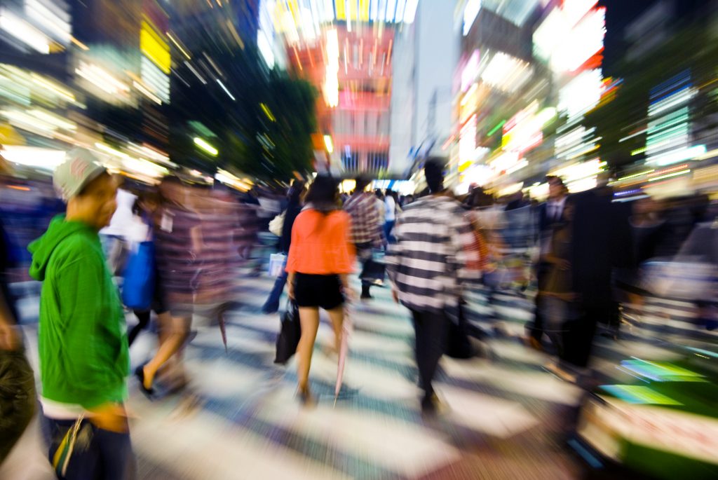 Concept of a fast paced modern world. Blurred people in busy city square moving quickly. The Timeless Journey of Massage: From Ancient Ritual to Modern Therapy